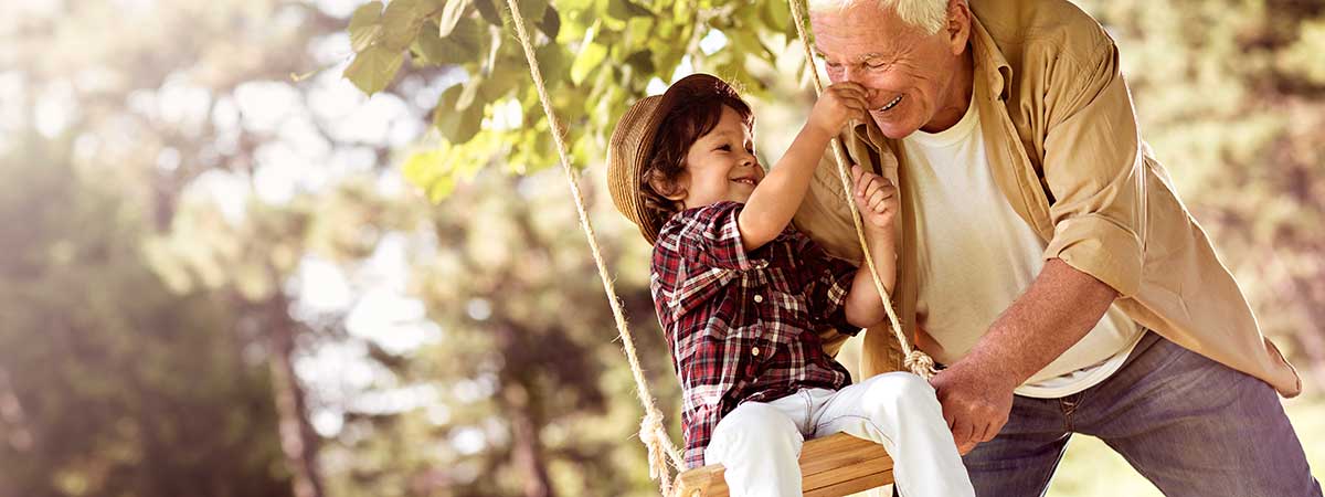 Grandfather pushing on swing