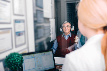 An older man finds out if he really has hearing loss by taking a hearing test at his favorite audiology clinic